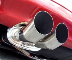 Exhaust pipes on a sleek red sports car, showcasing quality automotive exhaust services.