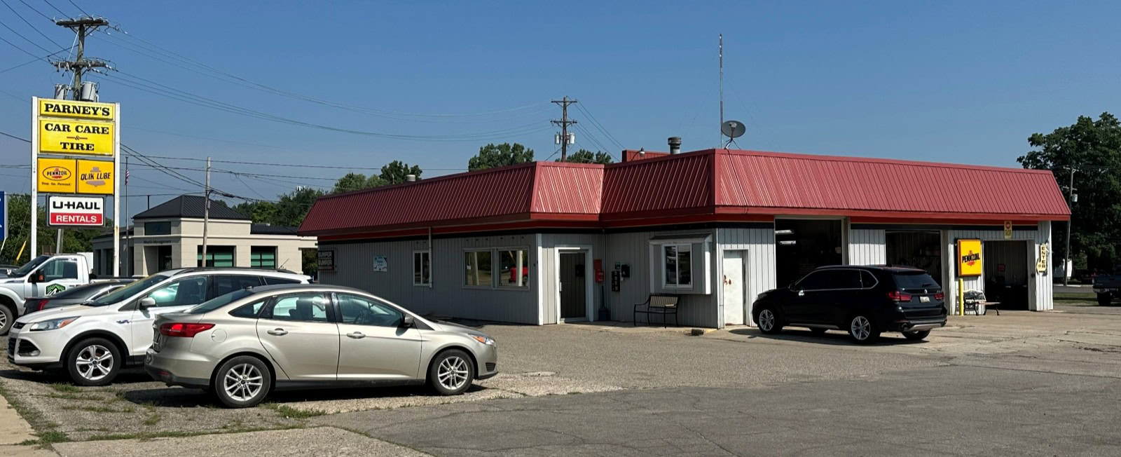 Parney’s Car Care auto repair shop with parking lot and building exterior.