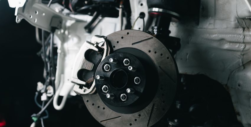 Close-up of a car brake rotor and caliper for maintenance.