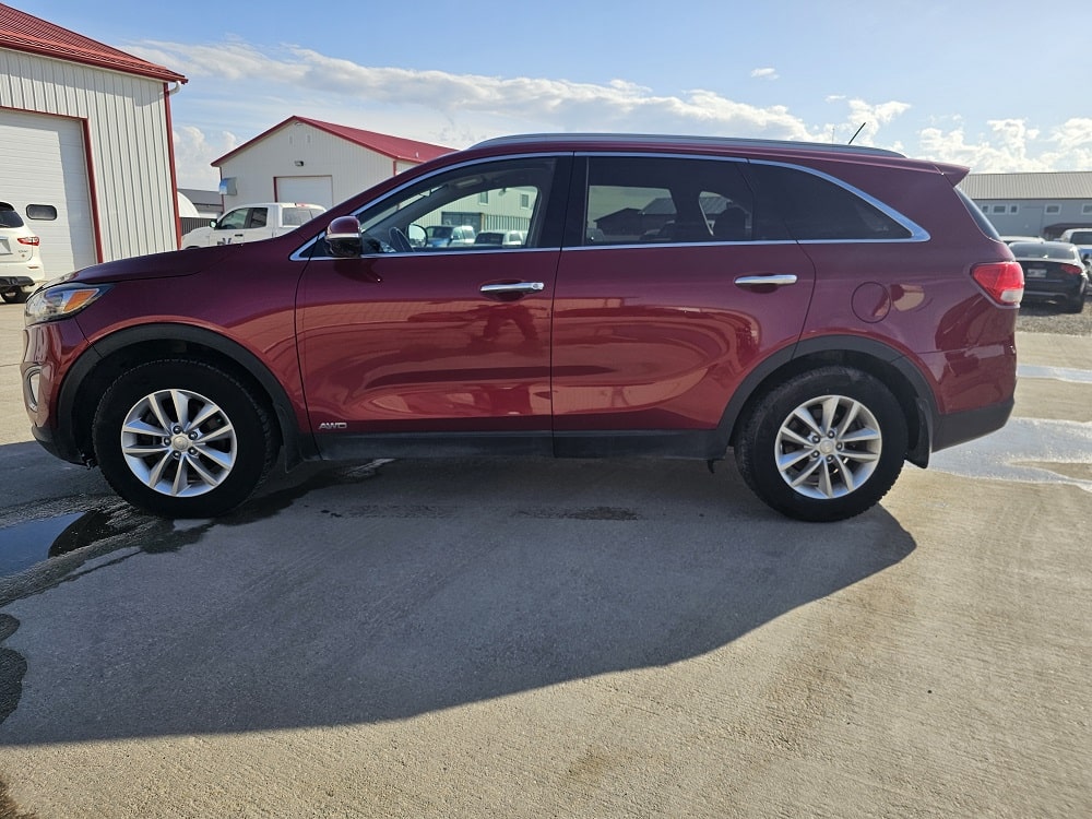 Red SUV parked outdoors with a clear sky background.