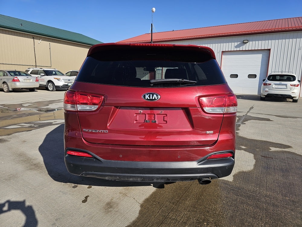 Red Kia Sorento SUV for sale at Pembina Valley Auto dealership.