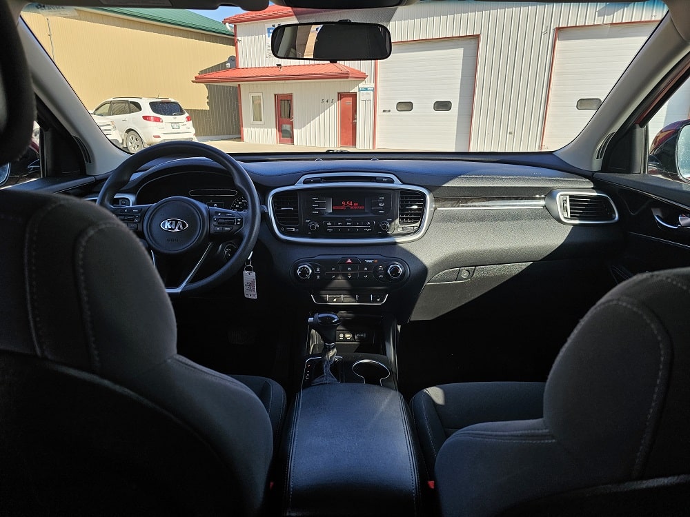 Interior view of a modern car dashboard and steering wheel.