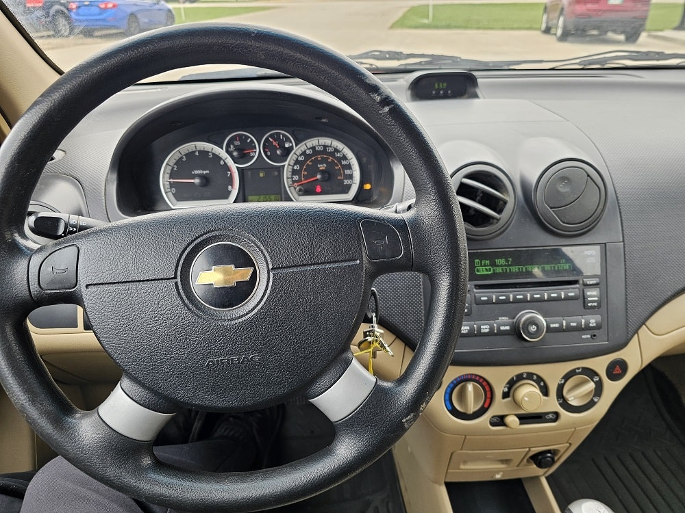 Interior view of a Chevrolet vehicle showing the dashboard, steering wheel, and control panel.