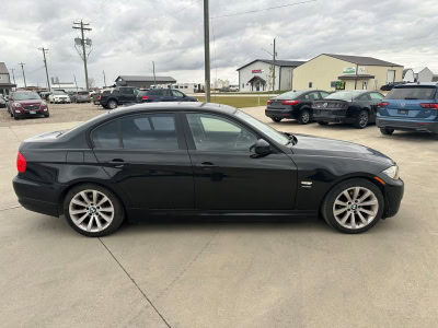 Black sedan parked in a dealership lot, showcasing quality used vehicles in Pembina Valley.