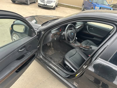 Interior view of a black sports car at Pembina Valley Auto dealership.