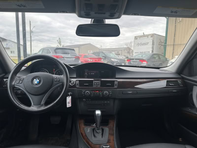 Interior view of a BMW vehicle with dashboard and steering wheel.