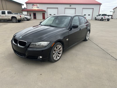 BMW sedan parked outside Pembina Valley Auto dealership.