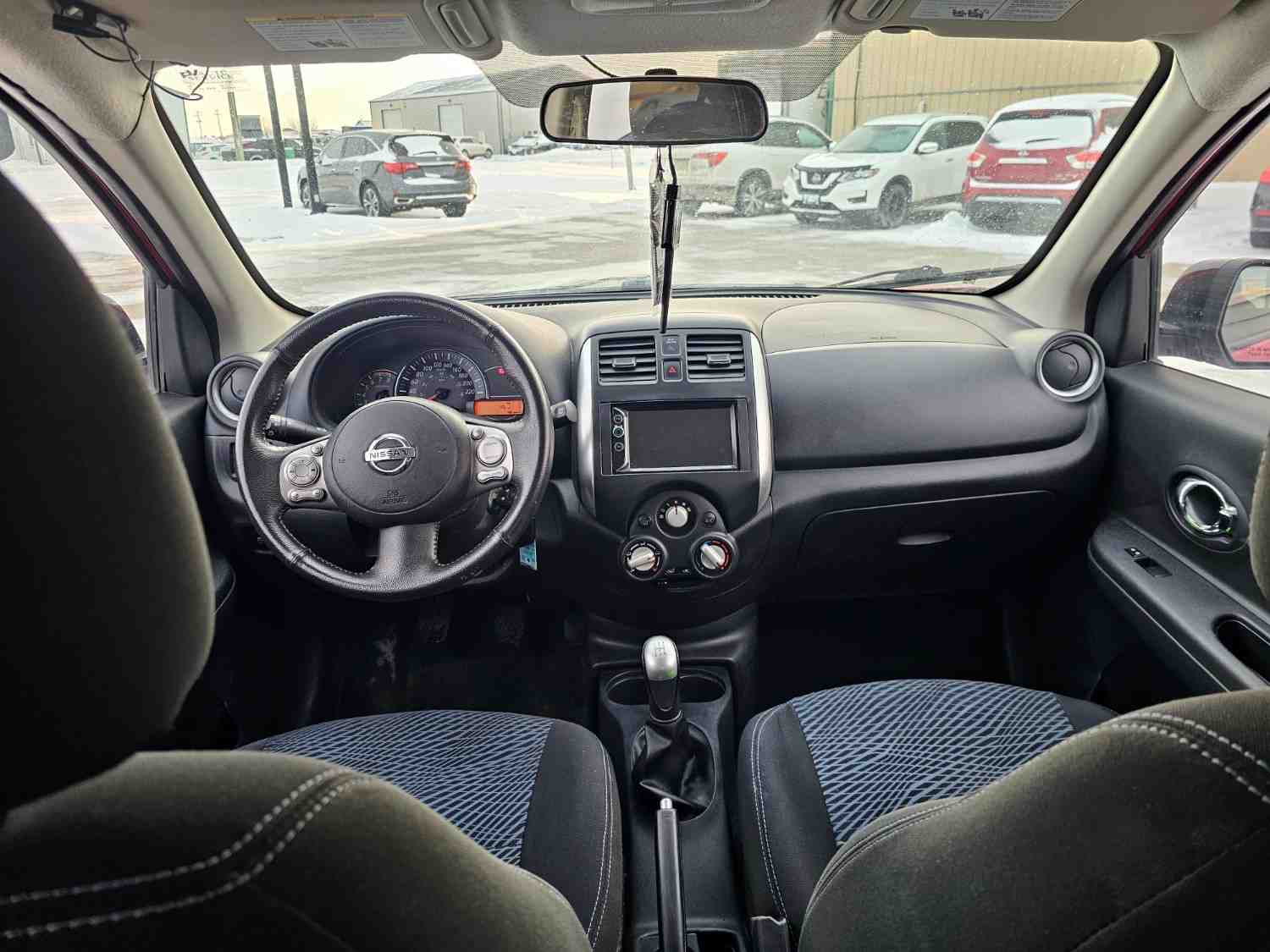 Interior view of Nissan car dashboard and steering wheel in Pembina Valley.