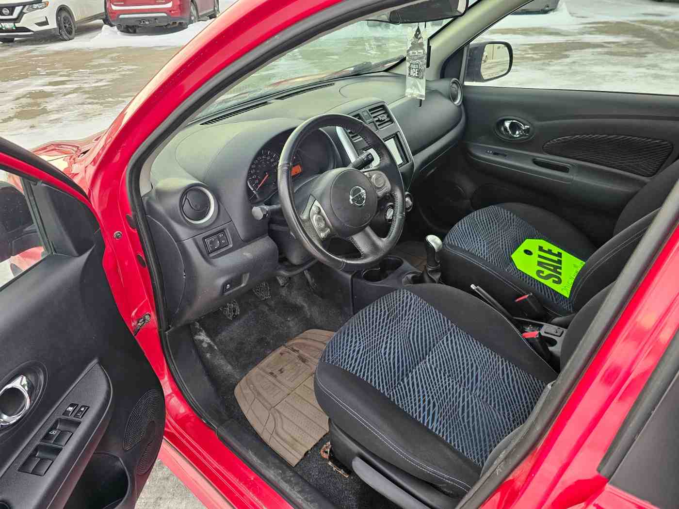 Interior view of a red vehicle showcasing the dashboard and front seats.