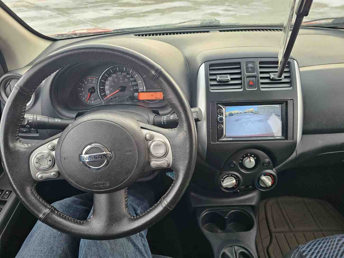 Car interior dashboard with steering wheel and navigation screen in Pembina Valley.