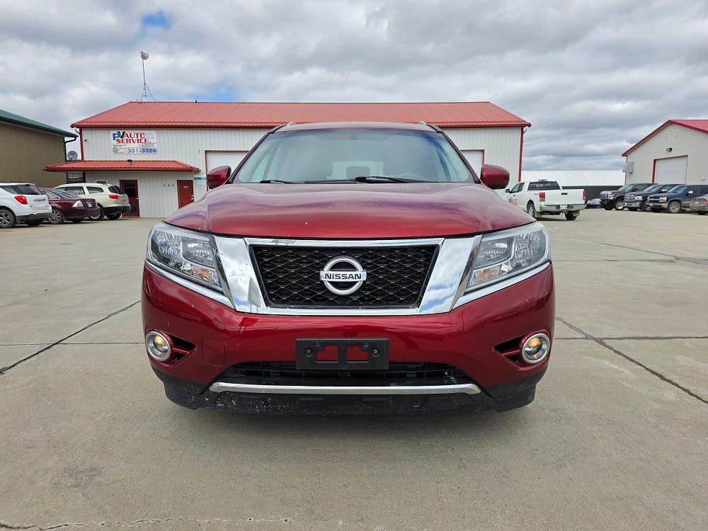 Red Nissan SUV parked in Pembina Valley auto dealership lot.