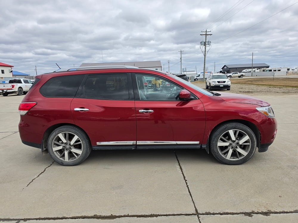 Red SUV parked at Pembina Valley Auto dealership in Manitoba.