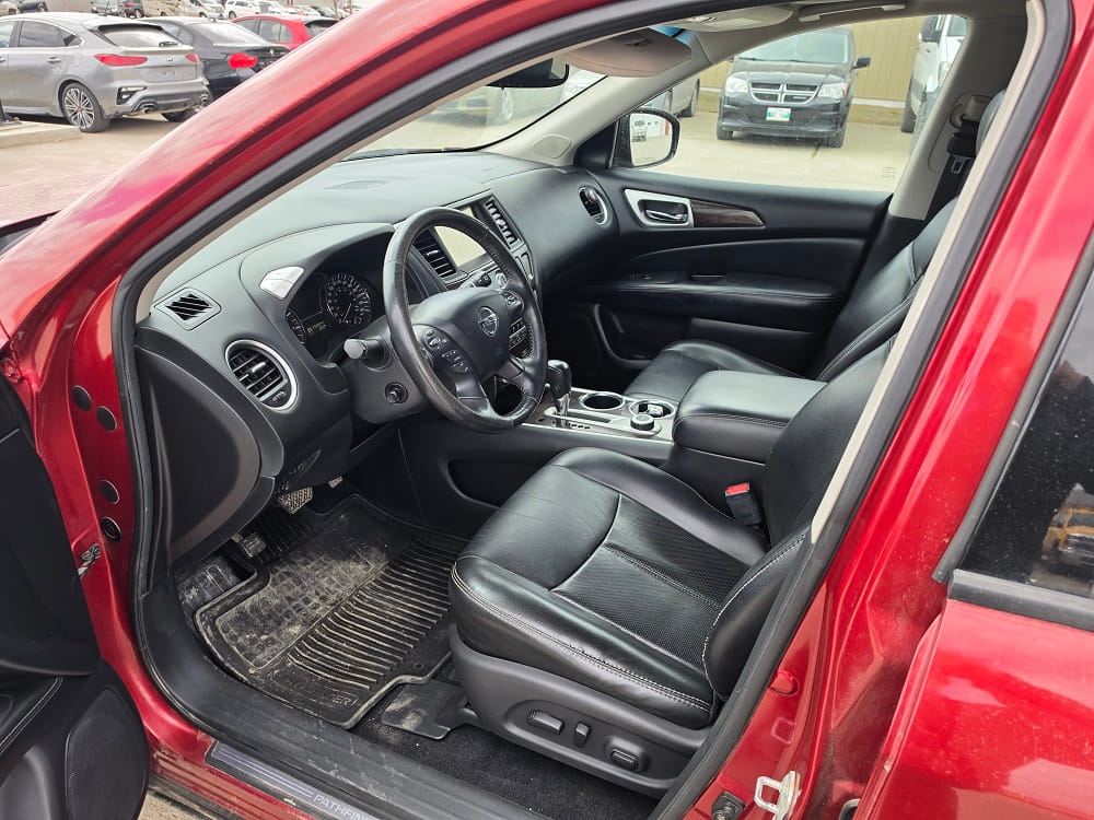 Interior view of a red vehicle at Pembina Valley Auto dealership.