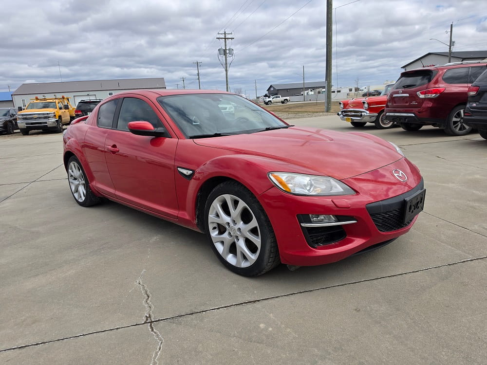 Red Mazda RX-8 sports car in excellent condition. Perfect for enthusiasts seeking performance and st.