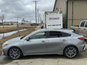 Silver sedan car in front of Pembina Valley Auto, Manitoba, Canada.