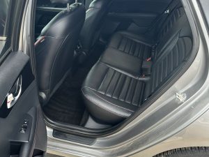 Interior view of a modern car with black leather seats.
