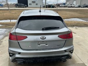 Silver Kia SUV parked outdoors in Pembina Valley with cloudy sky.