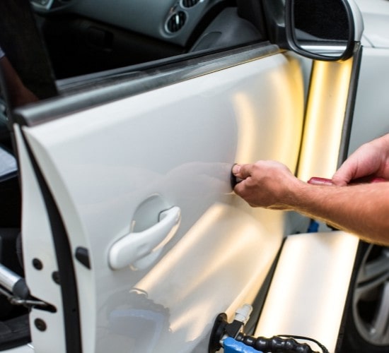 Professional car door dent repair service at Penguin Auto for seamless vehicle restoration.