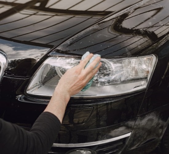 Headlight cleaning service for cars at Penguin Auto, ensuring clear, bright headlights for safe driv.