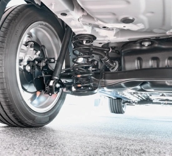 Suspension system and wheel assembly of a vehicle, showing detailed undercarriage components.
