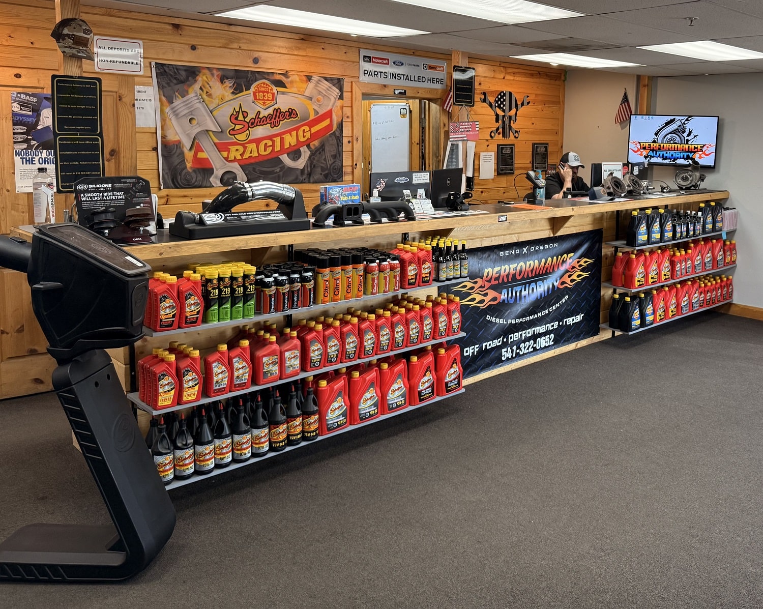 Auto parts store with shelves of car fluids and accessories at Performance Authority.