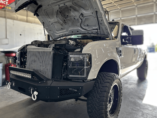 Custom off-road truck with open hood at Performance Authority.