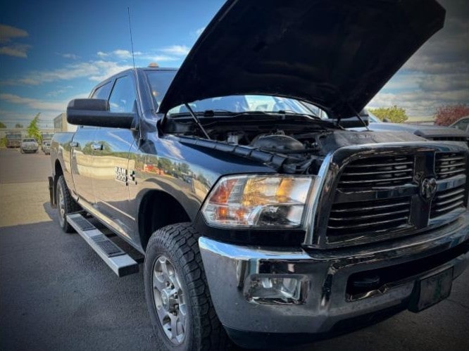 Black pickup truck with open hood at Performance Authority in Bend, OR.