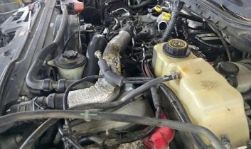 Engine bay of a vehicle at Performance Authority, showcasing maintenance and repair services.