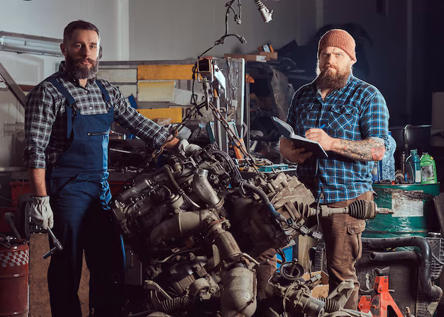 bearded-expert-mechanic-records-results-inspecting-car-while-his-partner-checking-problem-with-car-engine-scene-from-service-station