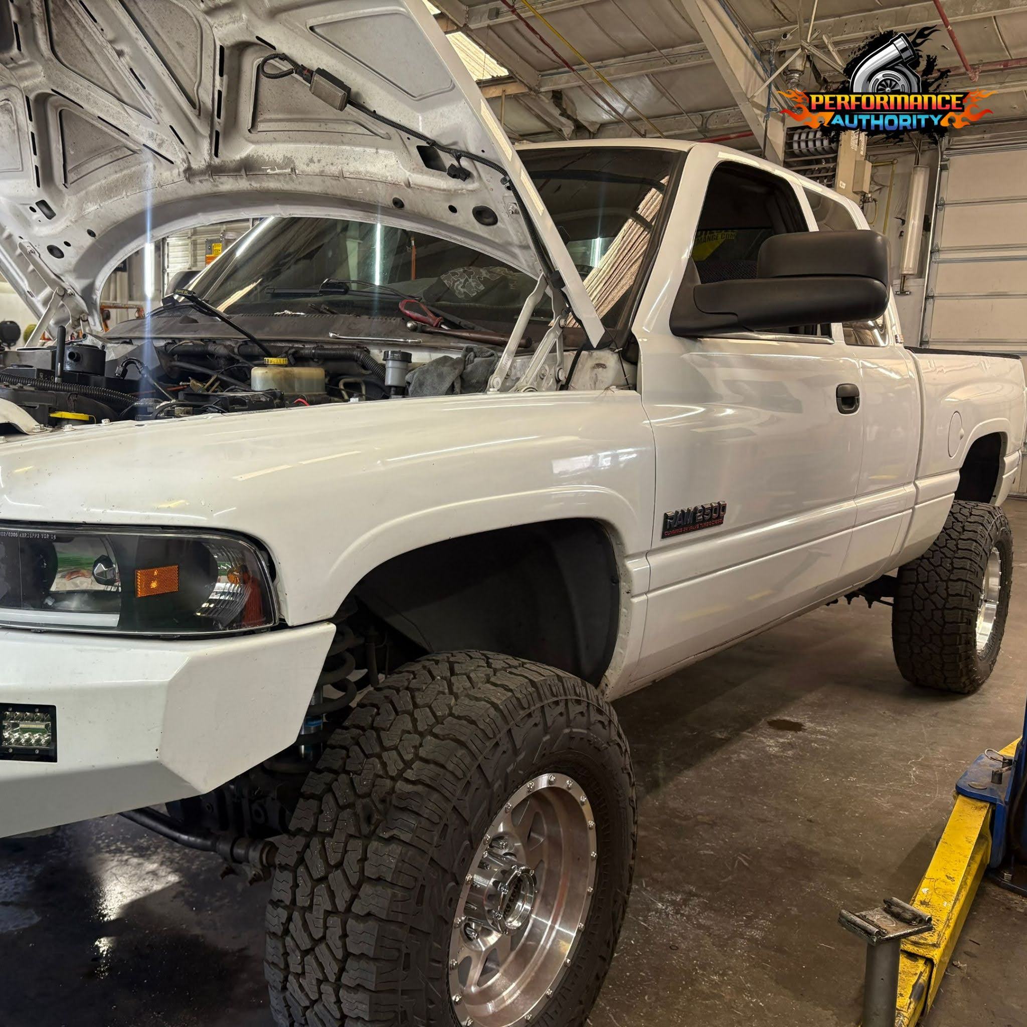 White pickup truck undergoing engine repair at Performance Authority in Bend, OR.