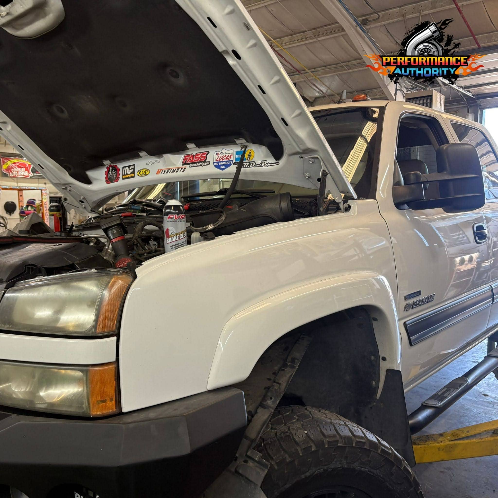 Custom truck engine bay at Performance Authority with open hood and performance upgrades.