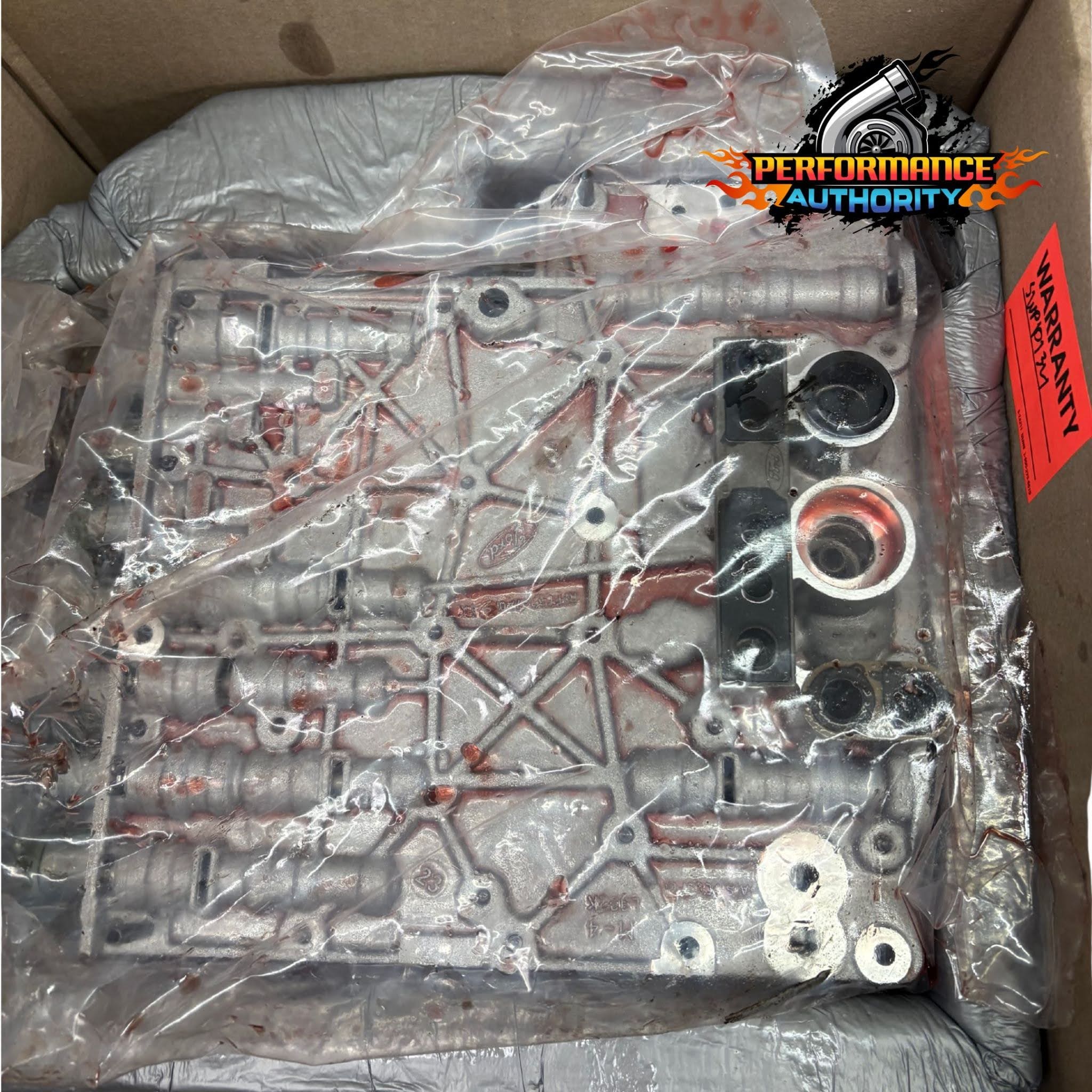 Engine component for performance upgrades, sealed in plastic.