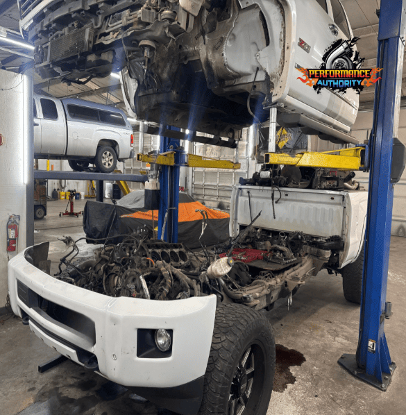 Vehicle on lift at Performance Authority for engine repair and maintenance.