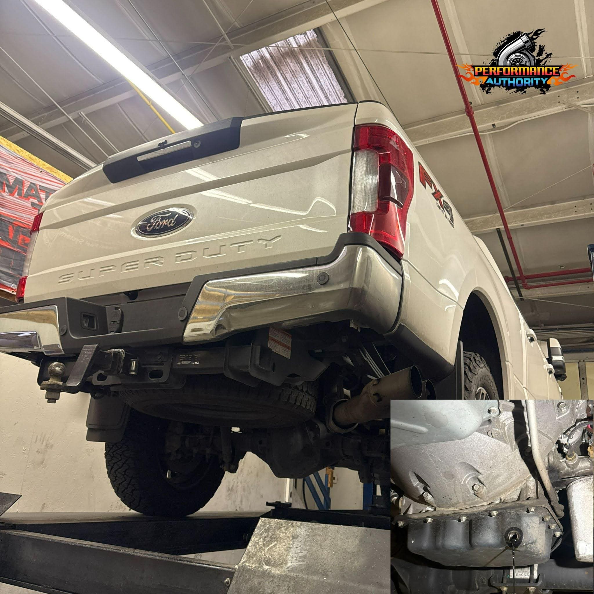 Ford Super Duty lifted truck in workshop for performance upgrades.