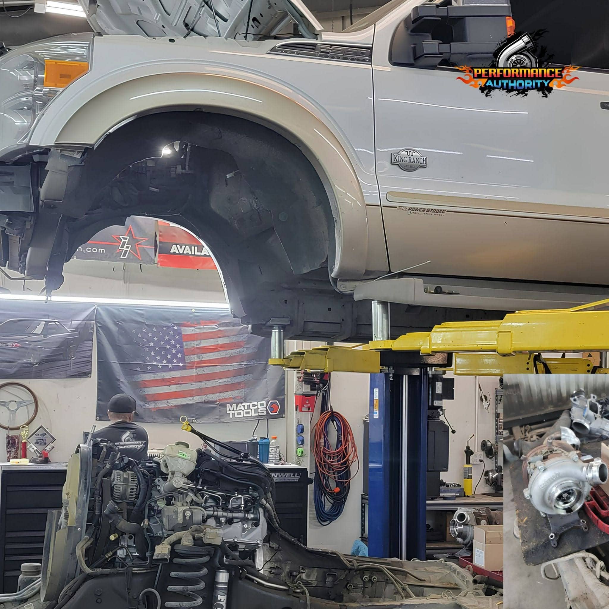 Auto repair shop with lifted truck and engine work in progress.