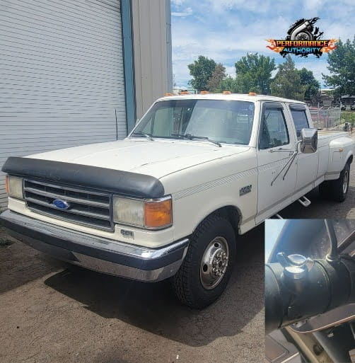White Ford F-250 pickup truck parked outside with Performance Authority logo in background.