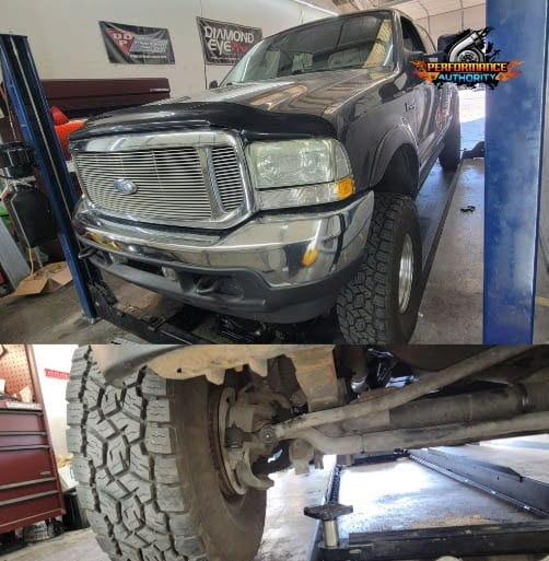 Ford truck undergoing repair with lifted front end and suspension work.