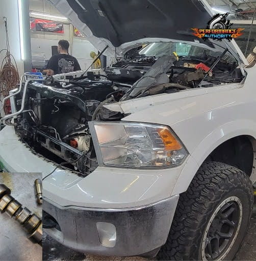 White truck with open hood during repair at Performance Authority.