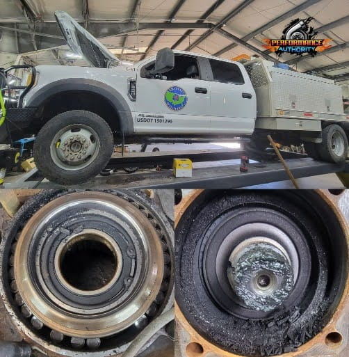 Service vehicle on lift with wheel and brake system close-up.
