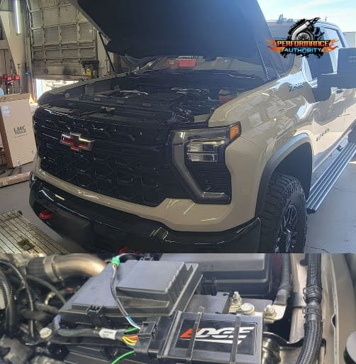 Chevrolet Silverado with open hood showing engine and performance modifications.