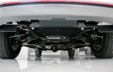 Underbody of a car with visible suspension and chassis for auto repair services.