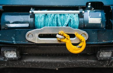 Heavy-duty vehicle winch with synthetic rope and hook for off-road recovery and towing services.