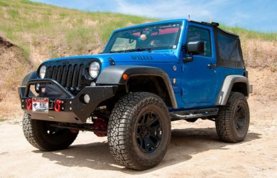 Off-road Jeep Wrangler in blue, rugged terrain, perfect for outdoor adventures and vehicle repairs.