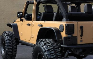 Jeep Wrangler off-road vehicle with rugged tires and open top, ideal for adventure and outdoor explo.