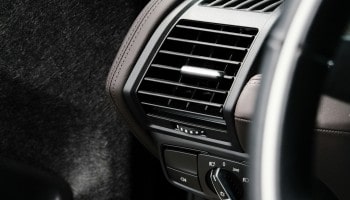 Air conditioning vent in vehicle interior for climate control.
