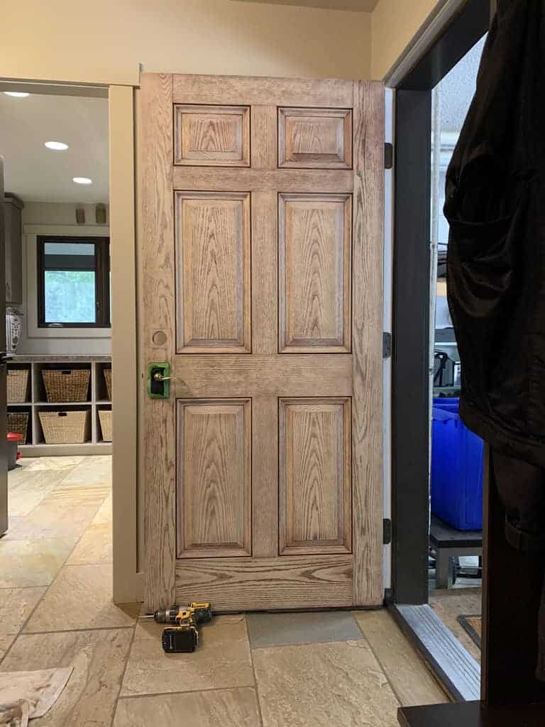 Wooden door partially open, tools nearby