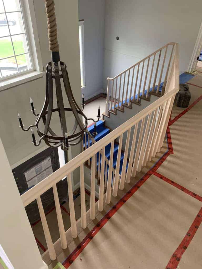 Staircase with chandelier and railing