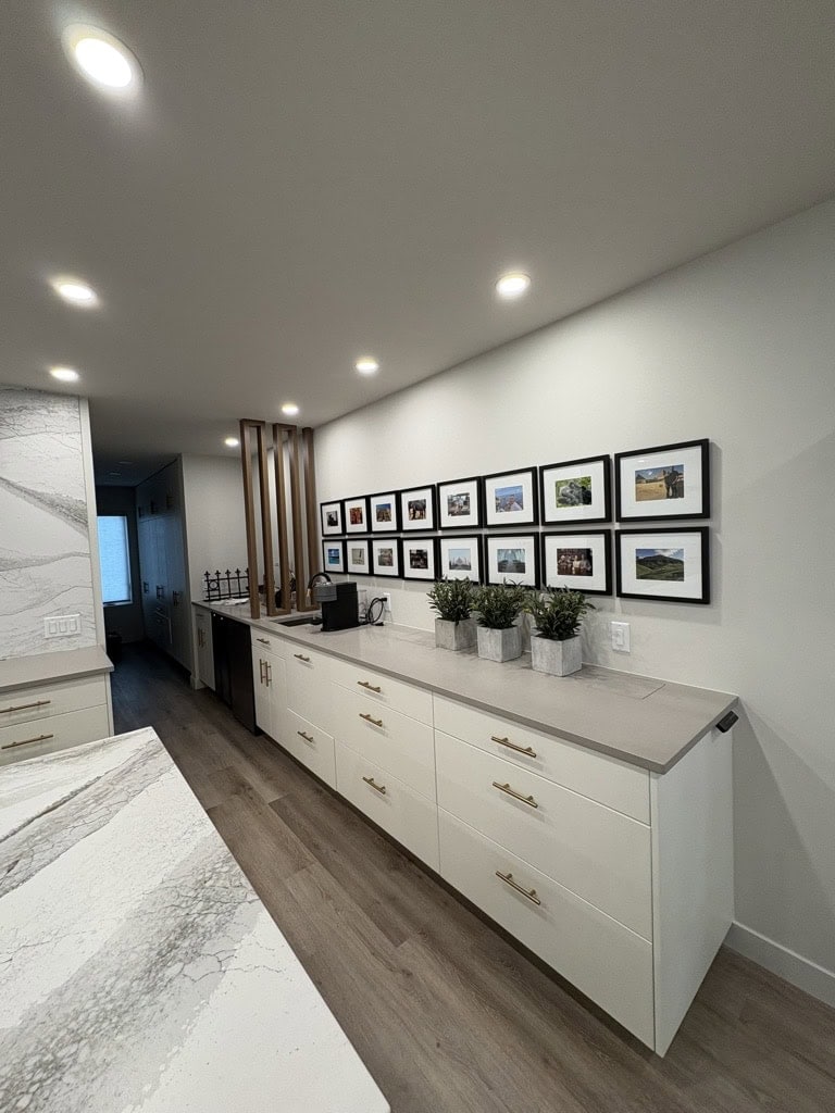Modern kitchen with framed photographs.