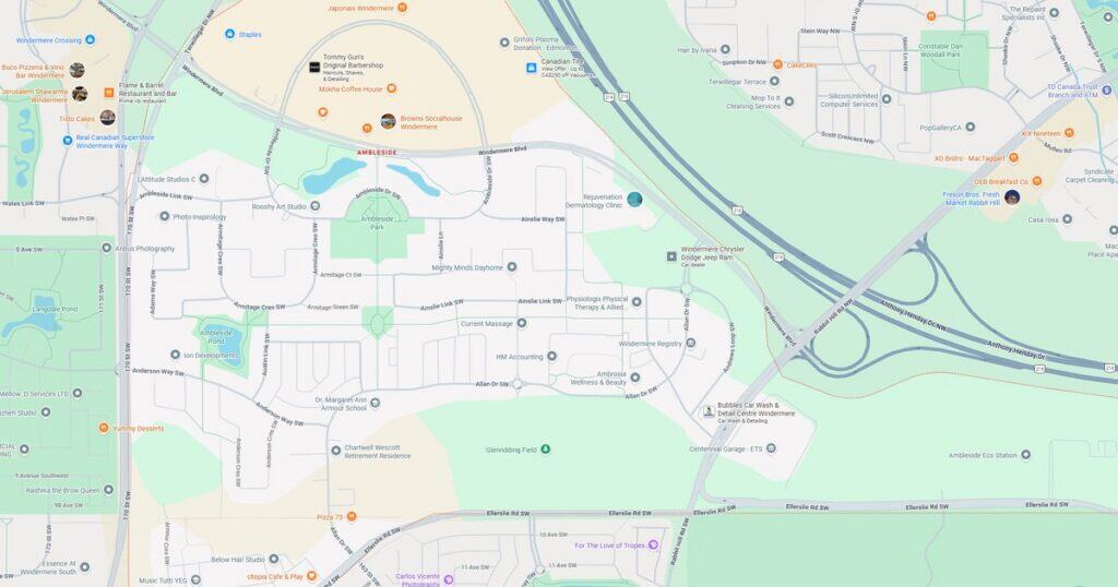 A scenic view of a city park at sunset, featuring a river, multiple bridges, and surrounding urban landscape with trees and pathways.