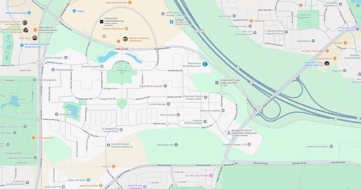 A scenic view of a city park at sunset, featuring a river, multiple bridges, and surrounding urban landscape with trees and pathways.